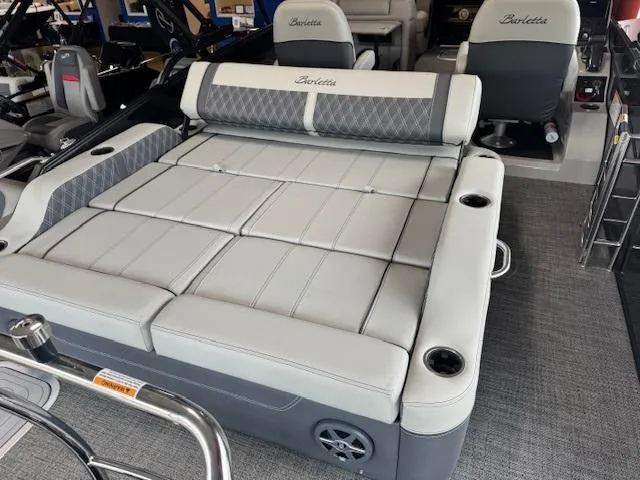Slide: The Image of 2025 Barletta Lusso 23UC pontoon boat interior with luxurious seating and cup holders. - 14