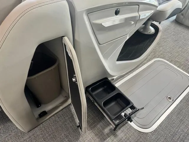 Slide: The Image of 2025 Barletta Lusso 23UC interior with storage compartment and cup holders. - 15