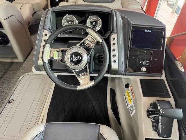 Slide: The Image of 2025 Barletta Lusso 23UC boat dashboard with steering wheel and control panel. - 6