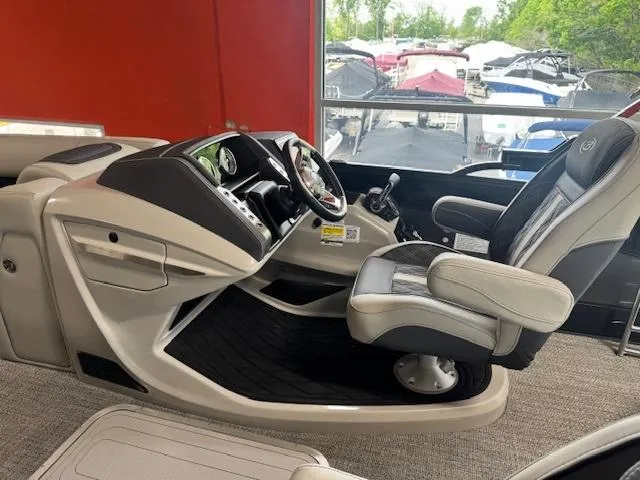 Slide: The Image of 2025 Barletta Lusso 23UC boat interior with modern helm and comfortable captain's chair. - 9