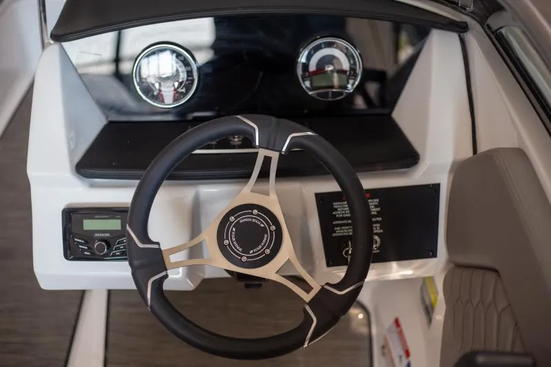 Slide: The Image of 2025 Four Winns H1 boat dashboard with steering wheel and gauges. - 6