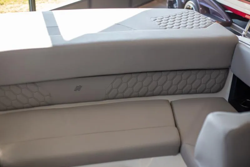 Slide: The Image of 2025 Four Winns H1 boat interior with sleek gray seating and hexagonal pattern design. - 9