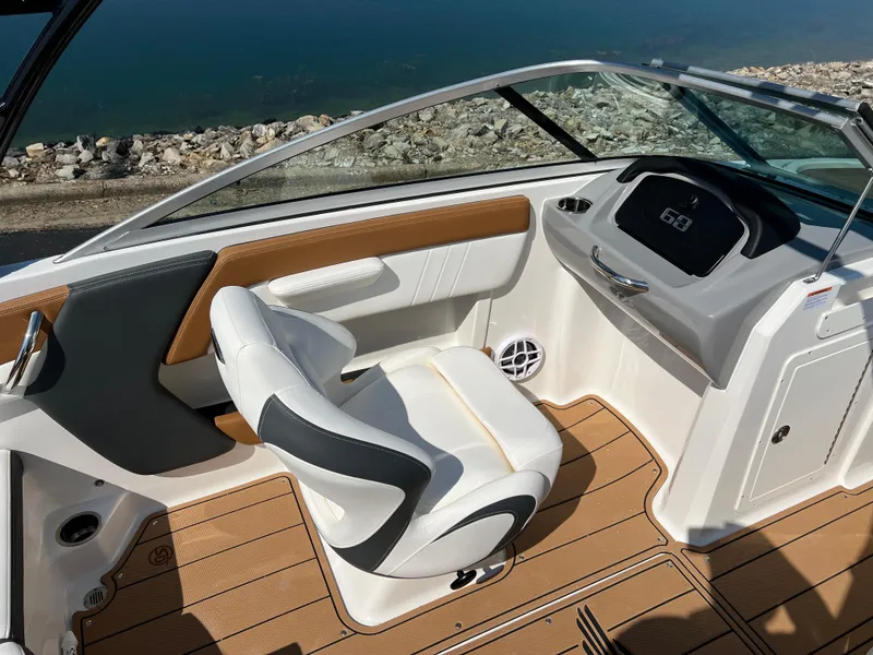 Slide: The Image of 2025 Chaparral 21 SSi boat interior with sleek seating and modern dashboard design. - 15