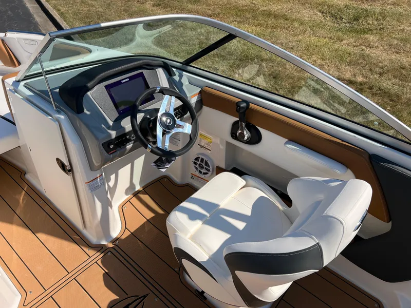 Slide: The Image of Interior of 2025 Chaparral 21 SSi boat with modern steering and seating. - 16