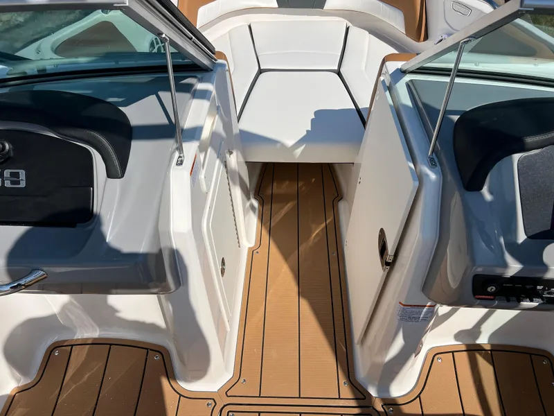 Slide: The Image of 2025 Chaparral 21 SSi boat interior with teak flooring and seating area. - 18
