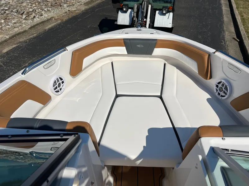 Slide: The Image of 2025 Chaparral 21 SSi boat interior with white and tan seating. - 19