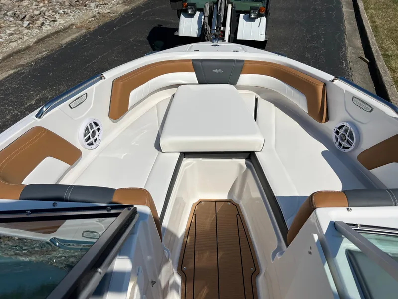 Slide: The Image of 2025 Chaparral 21 SSi boat interior with tan and white seating, wood accents. - 20