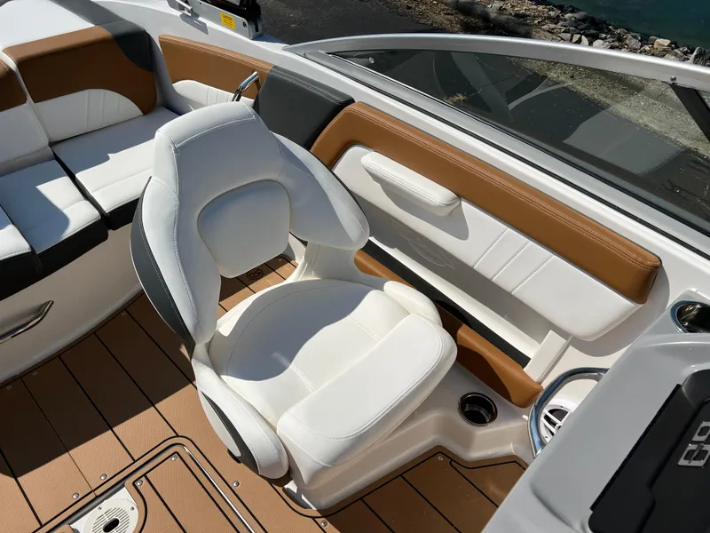 Slide: The Image of 2025 Chaparral 21 SSi boat interior with white and brown seating. - 23