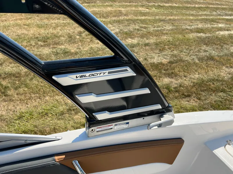 Slide: The Image of 2025 Chaparral 21 SSi boat interior with Velocity branding, black and brown accents. - 26