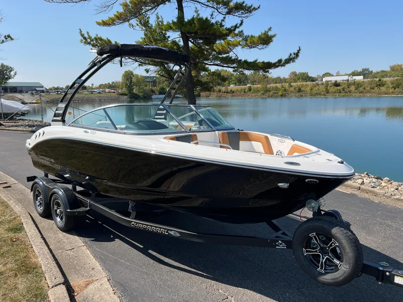 Slide: The Image of 2025 Chaparral 21 SSi boat on trailer by a lake. - 3