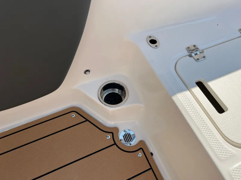 Slide: The Image of 2025 Chaparral 21 SSi boat deck with cup holder and storage compartment. - 30