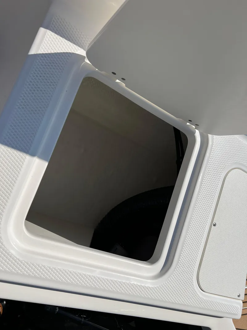 Slide: The Image of Open storage compartment in 2025 Chaparral 21 SSi boat. - 31