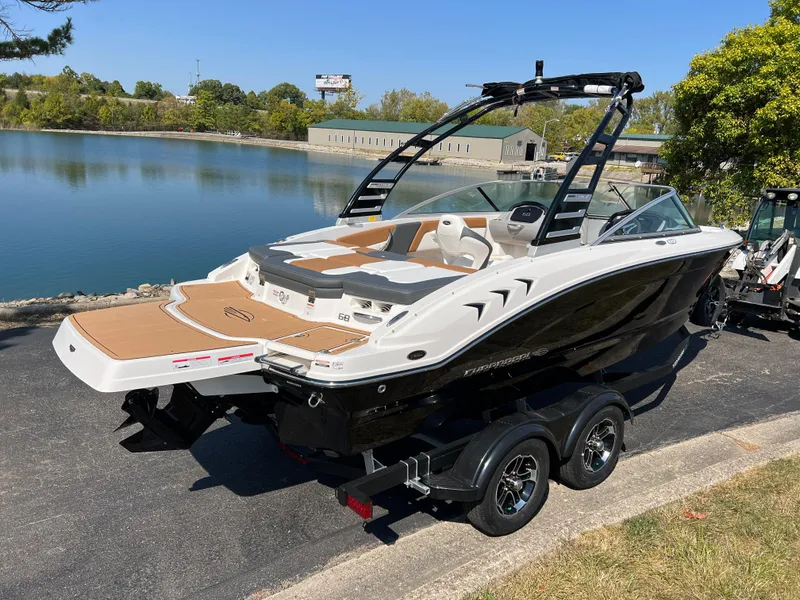 Slide: The Image of 2025 Chaparral 21 SSi boat on trailer by a lake, sunny day. - 4