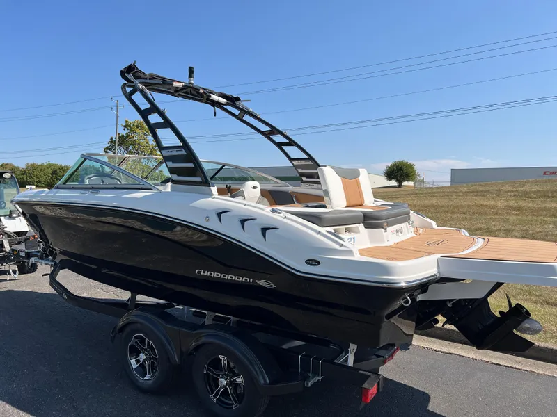 Slide: The Image of 2025 Chaparral 21 SSi boat on trailer, sleek design, black and white exterior. - 7