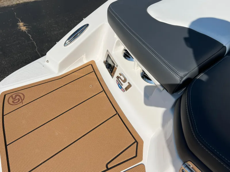 Slide: The Image of 2025 Chaparral 21 SSi boat interior with tan flooring and black seating. - 9