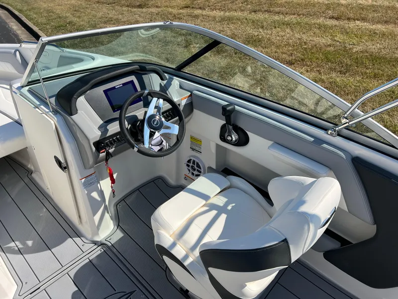 Slide: The Image of 2025 Chaparral 21 SSi boat interior with steering wheel and seating. - 12