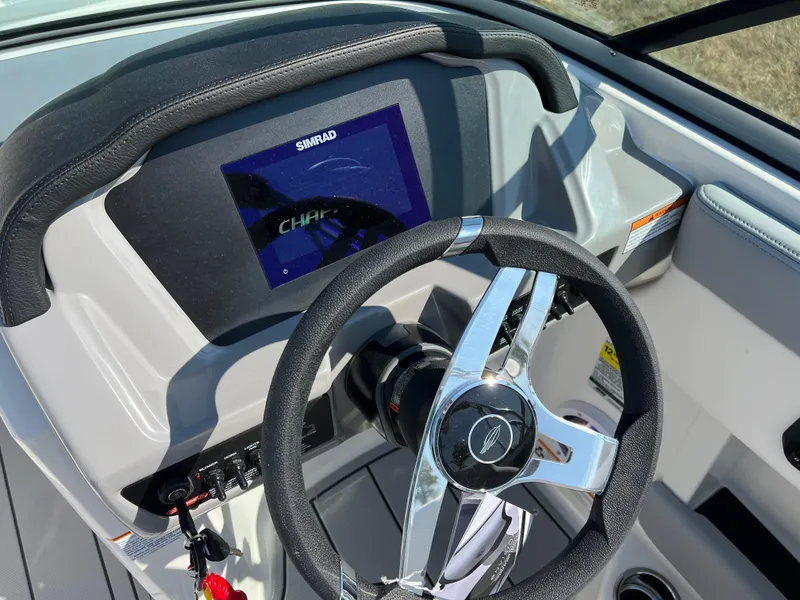 Slide: The Image of 2025 Chaparral 21 SSi boat dashboard with steering wheel and digital display. - 13