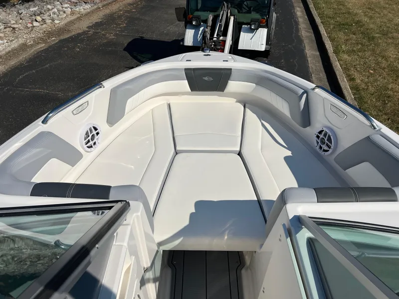 Slide: The Image of 2025 Chaparral 21 SSi boat interior with white seating and speakers. - 15