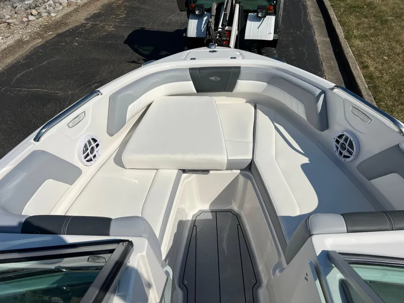 Slide: The Image of 2025 Chaparral 21 SSi boat interior with white seating and speakers. - 16
