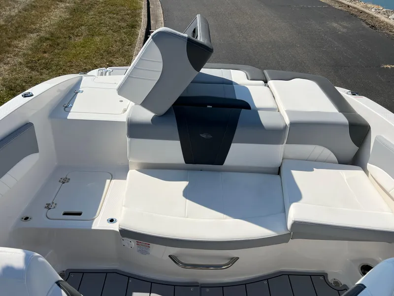 Slide: The Image of 2025 Chaparral 21 SSi boat interior with white and gray seating. - 20