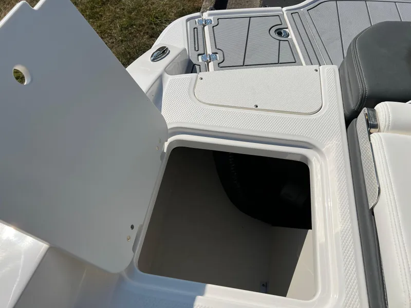 Slide: The Image of 2025 Chaparral 21 SSi boat storage compartment with open hatch. - 22