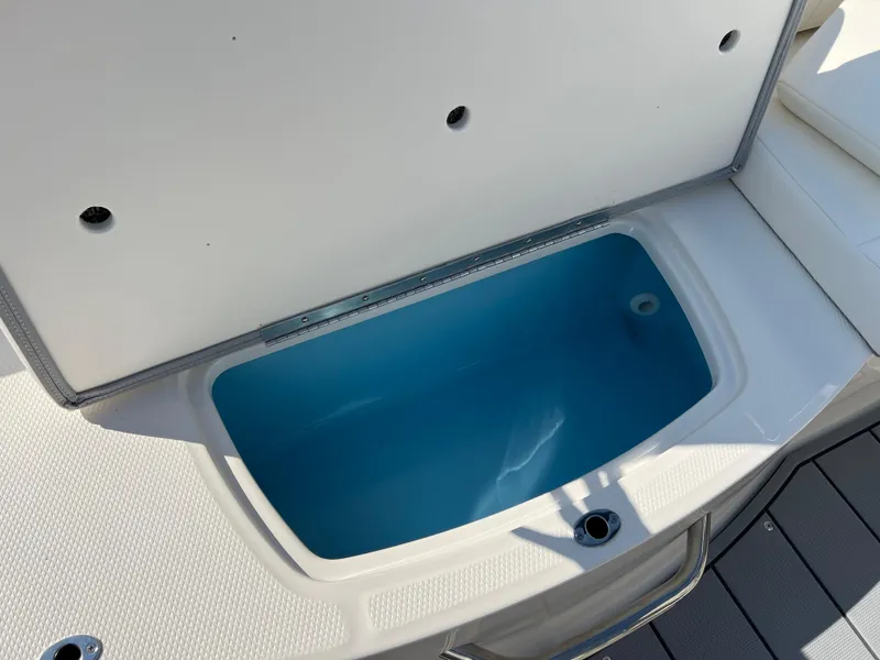 Slide: The Image of 2025 Chaparral 21 SSi boat storage compartment, open and empty. - 24