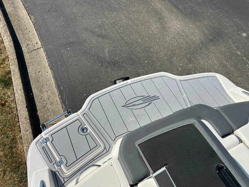 Slide: The Image of 2025 Chaparral 21 SSi boat deck with sleek design and logo. - 25