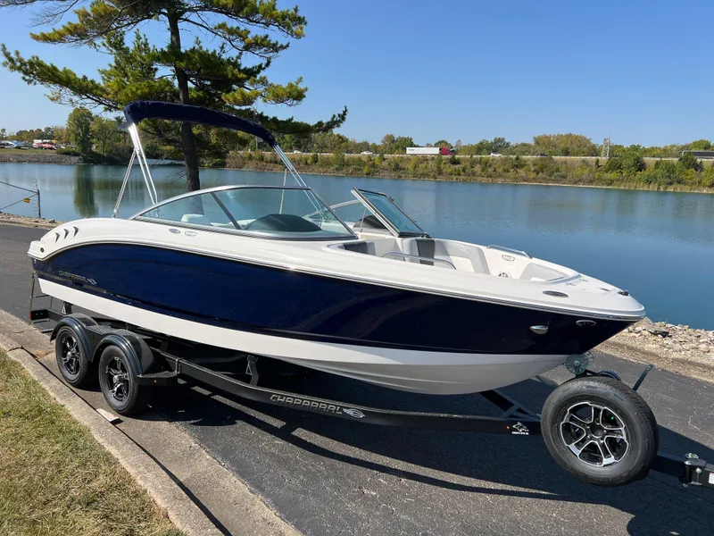 Slide: The Image of 2025 Chaparral 21 SSi boat on trailer by a scenic lake. - 3