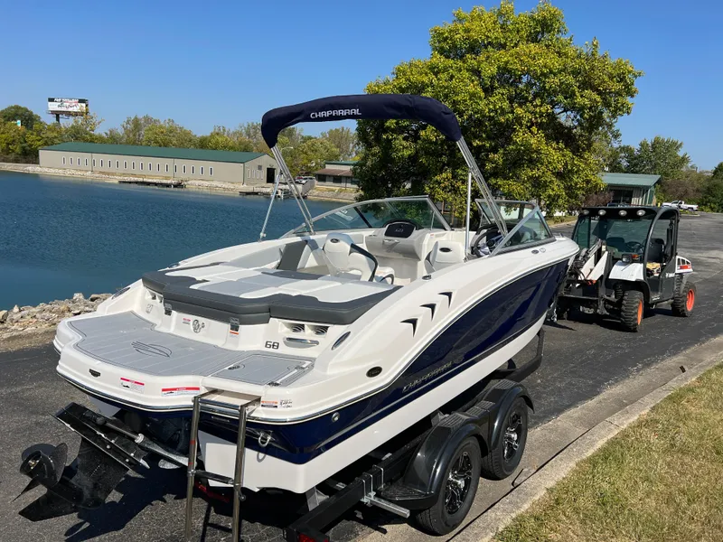 Slide: The Image of 2025 Chaparral 21 SSi boat on trailer by a lake, ready for launch. - 4