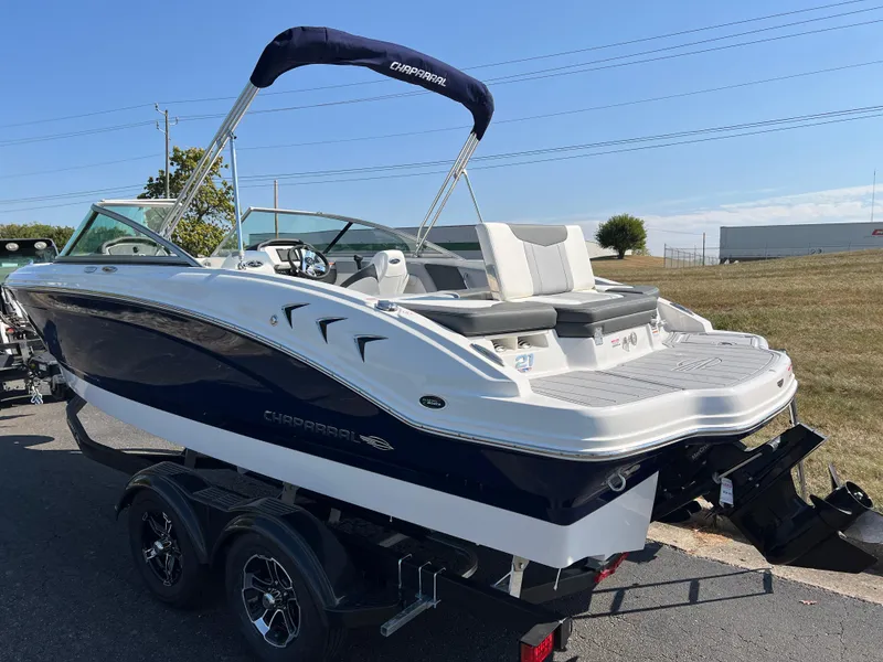 Slide: The Image of 2025 Chaparral 21 SSi boat on trailer, sleek design, outdoor setting. - 6