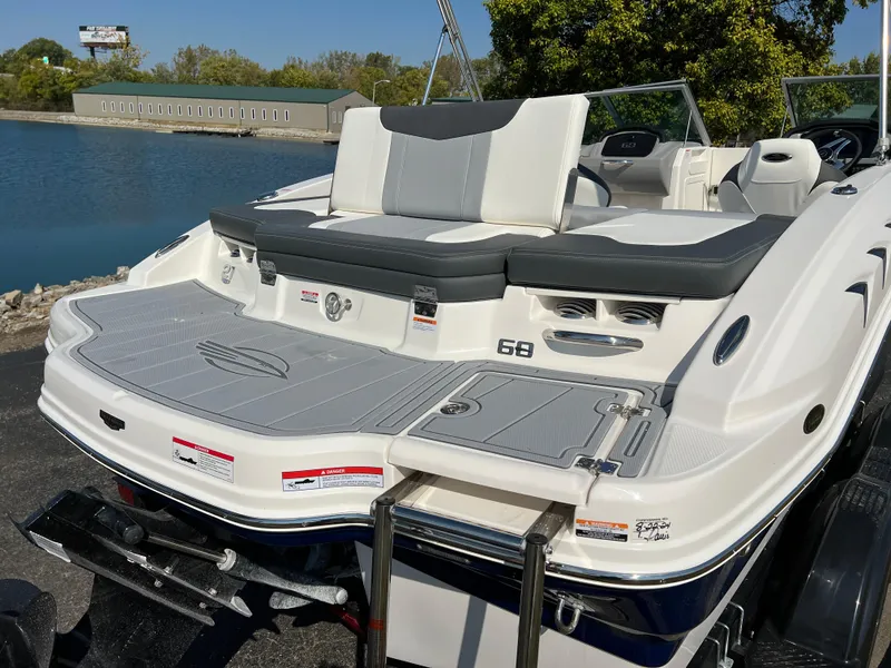 Slide: The Image of 2025 Chaparral 21 SSi boat with sleek design, docked by a serene lake. - 7