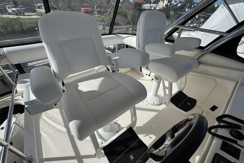 Slide: The Image of Captain's chairs on 2008 Sea Ray 58 Sedan Bridge yacht, featuring sleek white upholstery. - 23