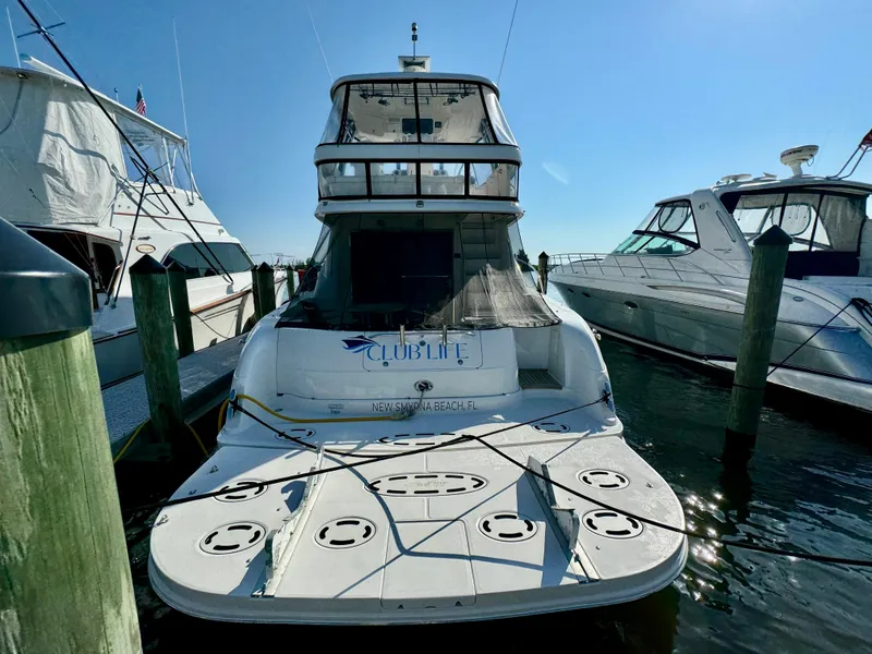 Slide: The Image of 2008 Sea Ray 58 Sedan Bridge yacht cruising on open water at sunset. - 3