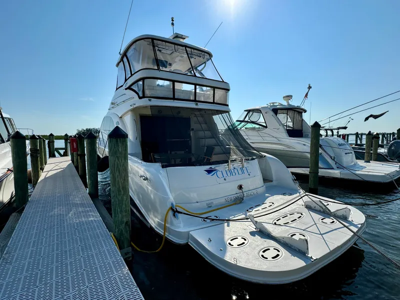 Slide: The Image of 2008 Sea Ray 58 Sedan Bridge yacht docked at marina, sunny day. - 4