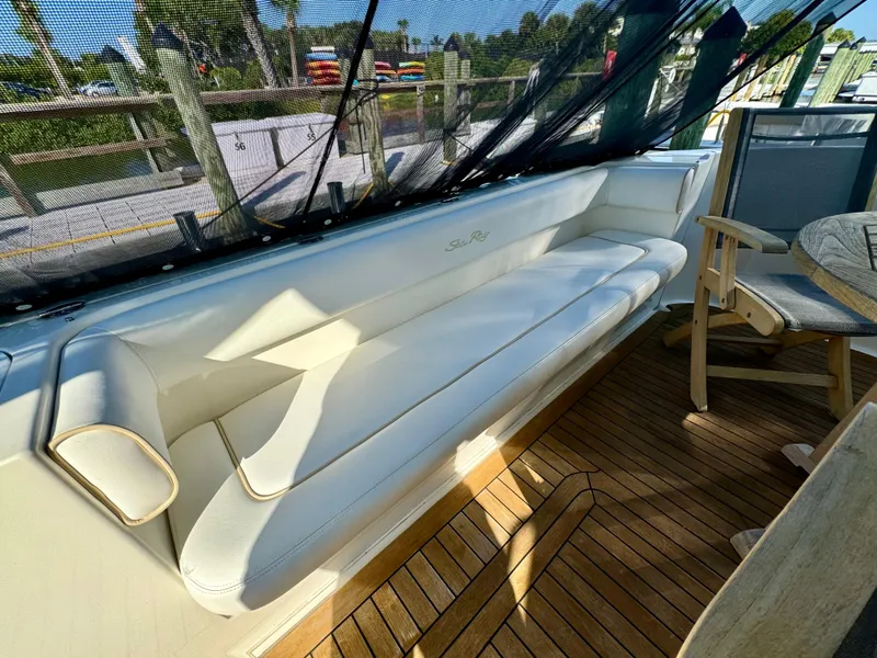 Slide: The Image of 2008 Sea Ray 58 Sedan Bridge yacht docked at marina under clear blue sky. - 6