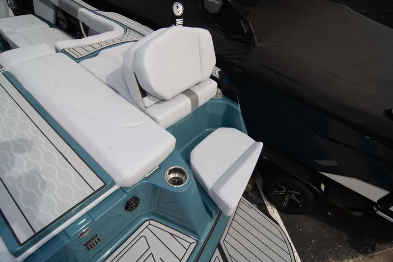 Slide: The Image of 2025 MasterCraft XT24 boat interior with white seating and teal accents. - 28