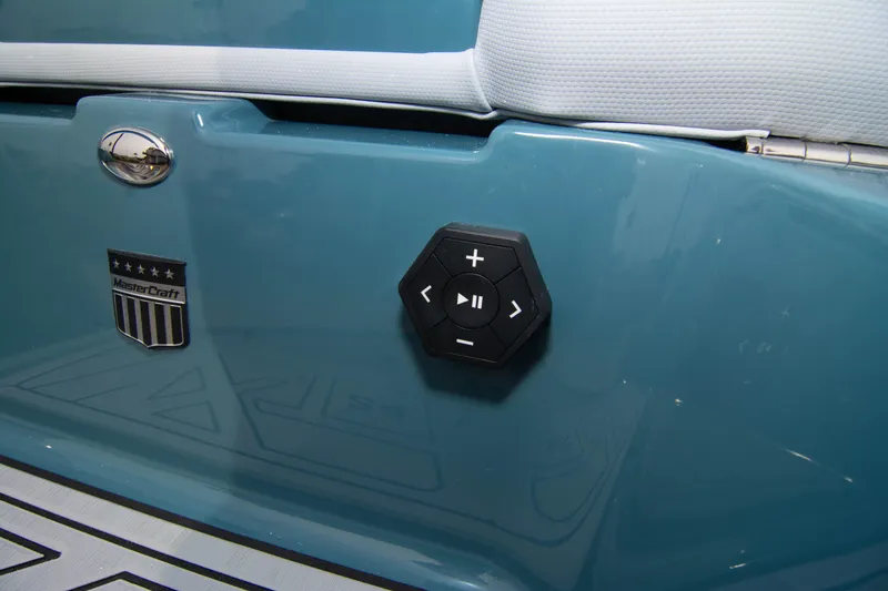 Slide: The Image of 2025 MasterCraft XT24 boat with control panel and logo on blue exterior. - 29