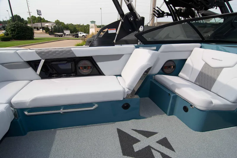 Slide: The Image of 2025 MasterCraft XT24 boat interior with white and teal seating, modern design, and premium finishes. - 36