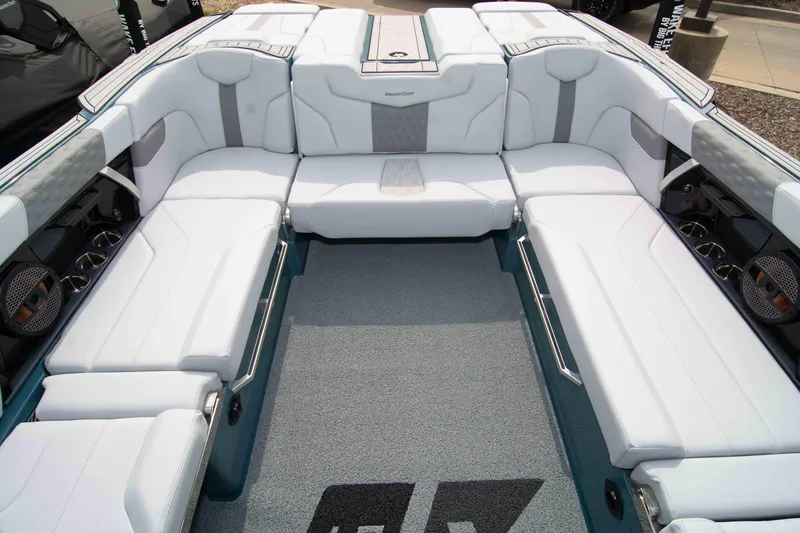Slide: The Image of 2025 MasterCraft XT24 boat interior with spacious white seating and modern design. - 37