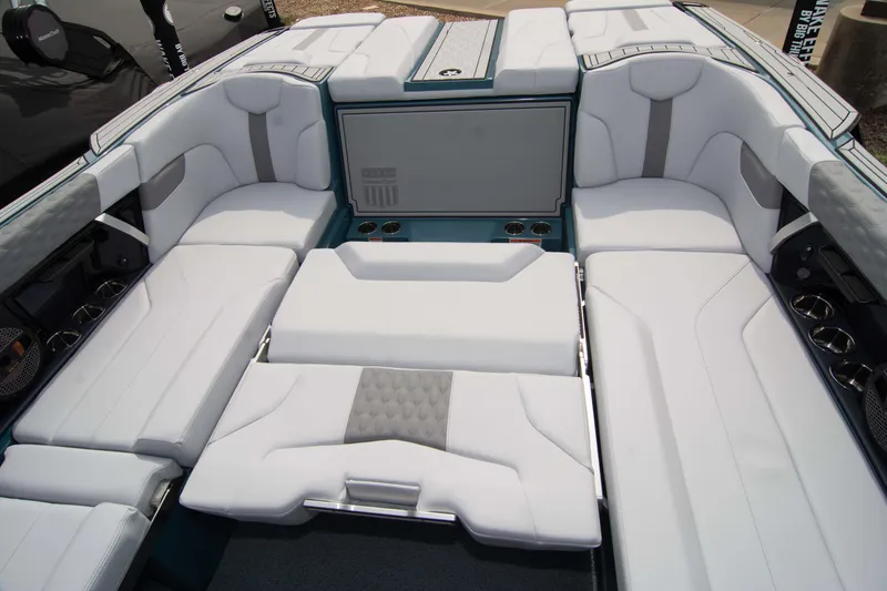 Slide: The Image of 2025 MasterCraft XT24 boat interior with luxurious white seating and modern design. - 40
