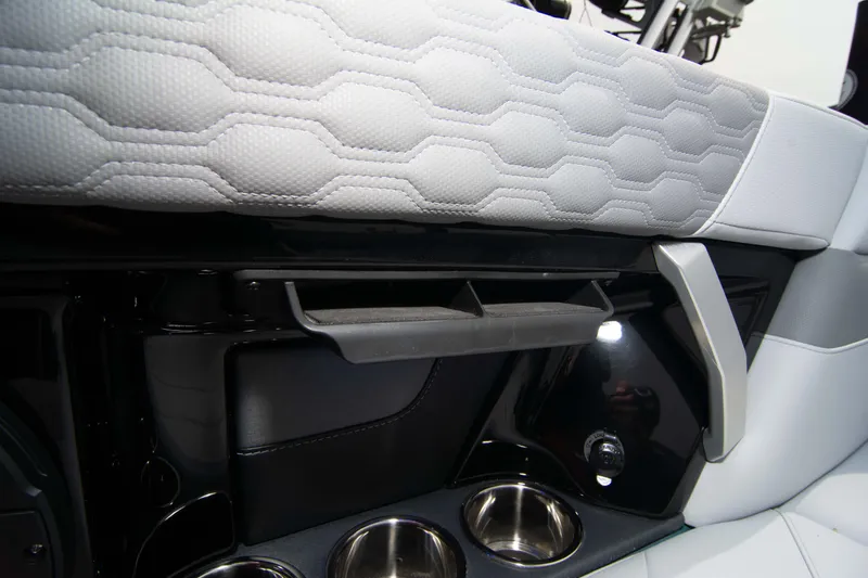 Slide: The Image of 2025 MasterCraft XT24 interior detail with cup holders and quilted upholstery. - 42