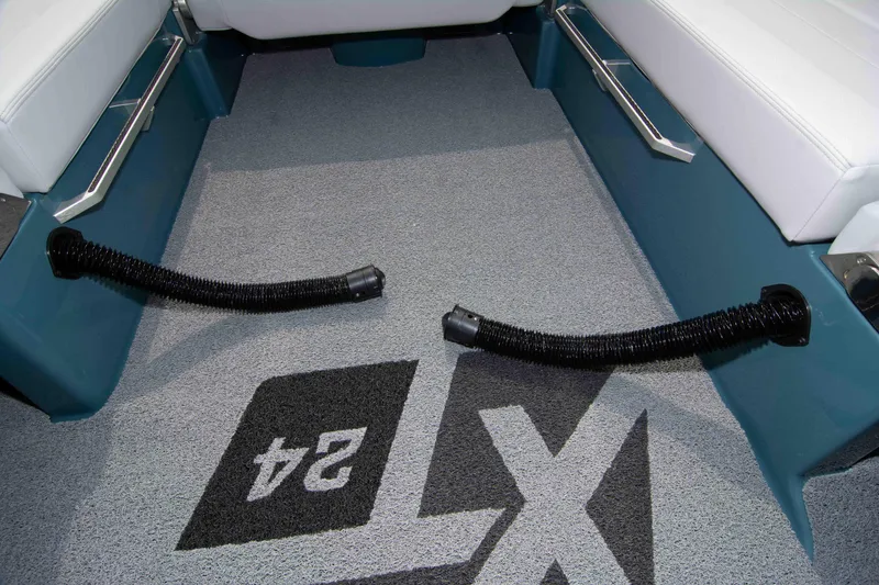 Slide: The Image of 2025 MasterCraft XT24 boat interior with custom flooring and seating. - 44