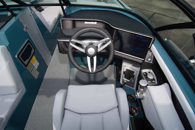 Slide: The Image of 2025 MasterCraft XT24 boat cockpit with modern steering and control panel. - 45