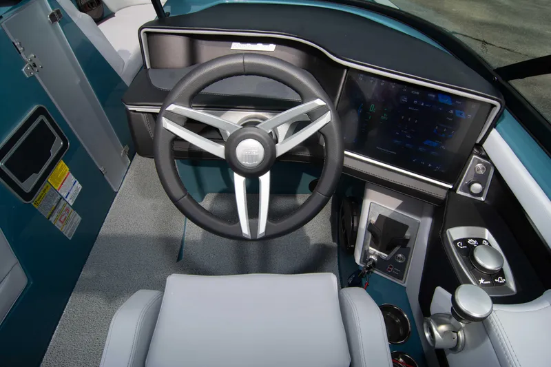 Slide: The Image of 2025 MasterCraft XT24 boat dashboard with modern steering wheel and digital display. - 46