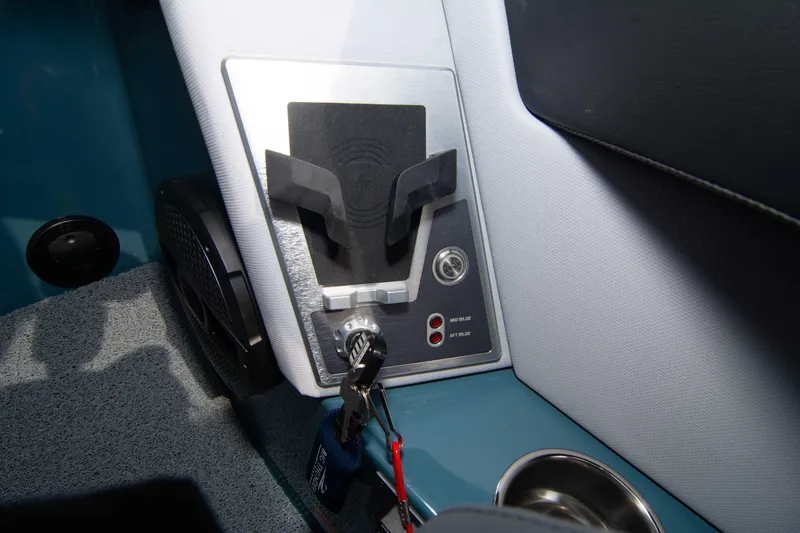 Slide: The Image of Control panel of 2025 MasterCraft XT24 boat with key ignition and cup holder. - 49
