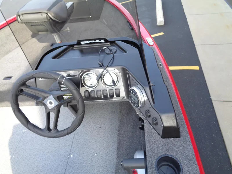 Slide: The Image of 2025 Lund 1650 Rebel XL SS boat dashboard with steering wheel and gauges. - 10