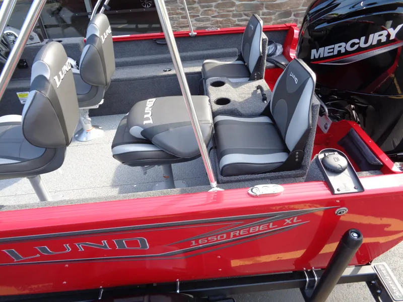 Slide: The Image of 2025 Lund 1650 Rebel XL SS boat interior with Mercury engine, featuring comfortable seating. - 3