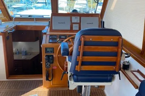 Slide: The Image of Grand Banks 49 Eastbay SX 2001 helm with wooden accents and navigation equipment. - 10