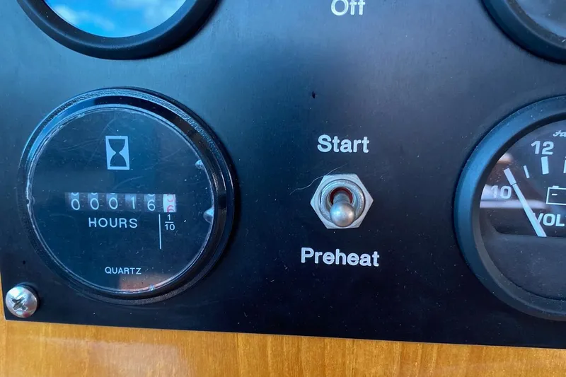 Slide: The Image of Dashboard of 2001 Grand Banks 49 Eastbay SX with hour meter and start switch. - 11