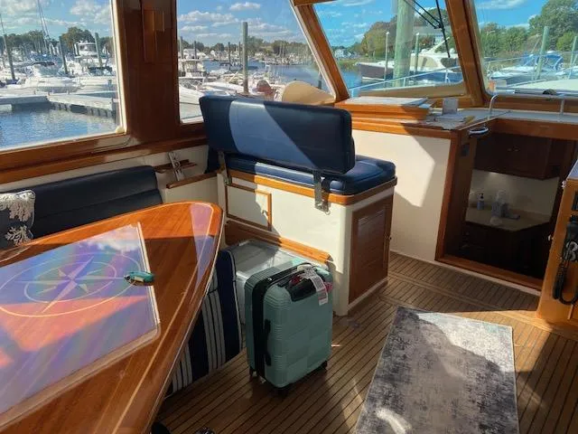 Slide: The Image of Interior of 2001 Grand Banks 49 Eastbay SX yacht with seating and luggage. - 14